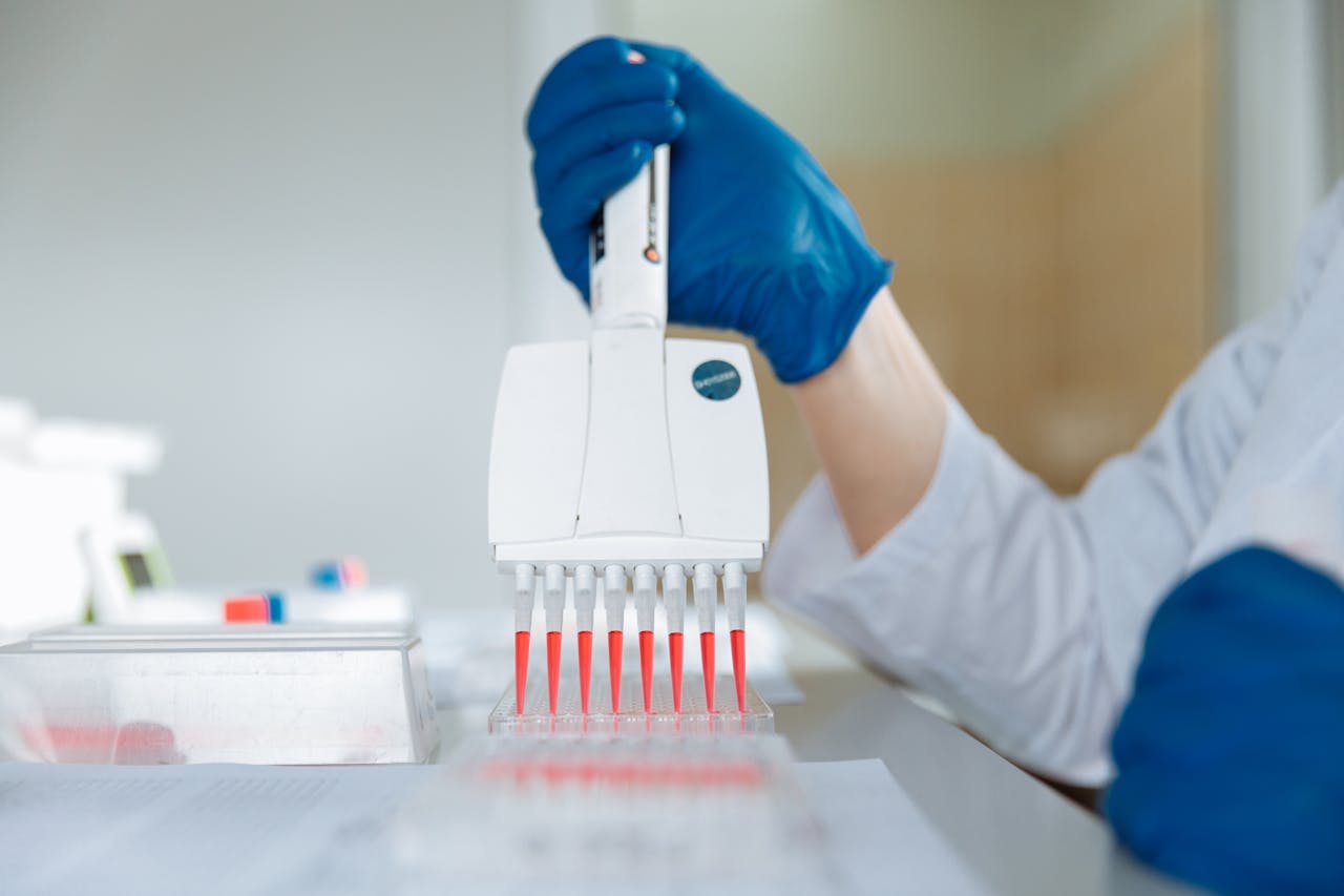 A laboratory technician using a multichannel pipette